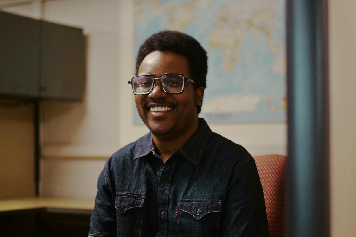 Student smiles at the camera inside CIE office. 